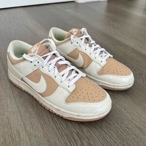 Women's Nike Dunk Low: beige and white.